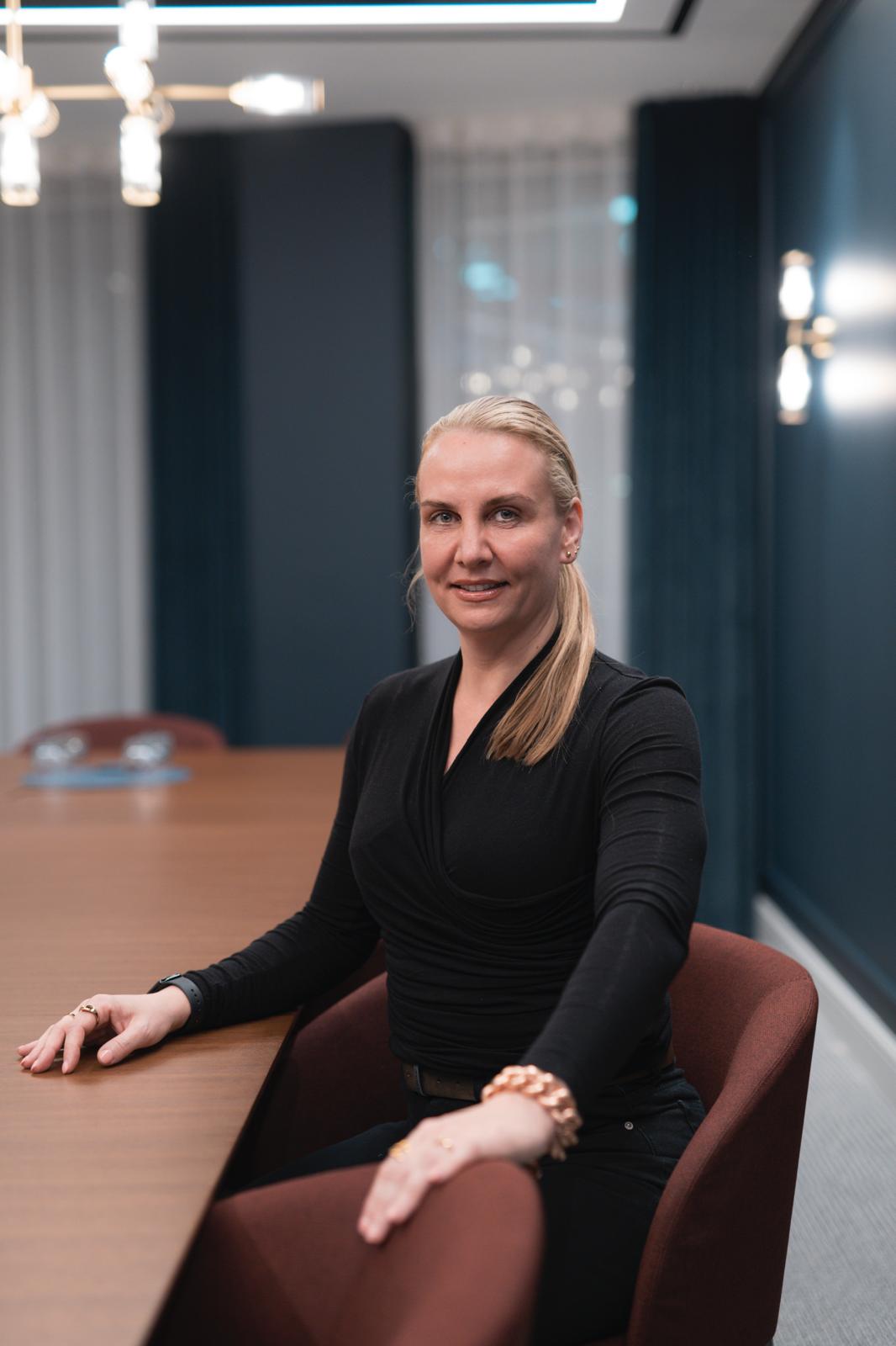 Karolina Lewandowska, founder of GroundBridge International, seated at a boardroom table